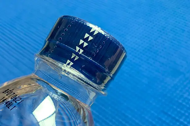shrink band showing perforation for easy tearing - tamper evidence